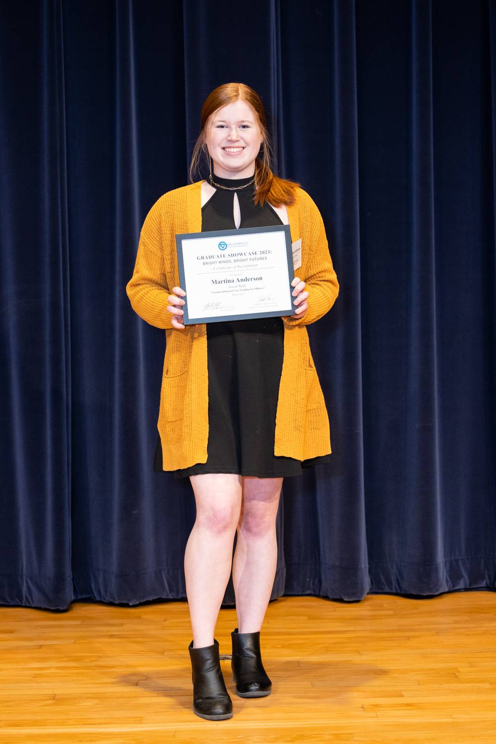 2023 Graduate Showcase participant, Martina Anderson, holding her certificate.